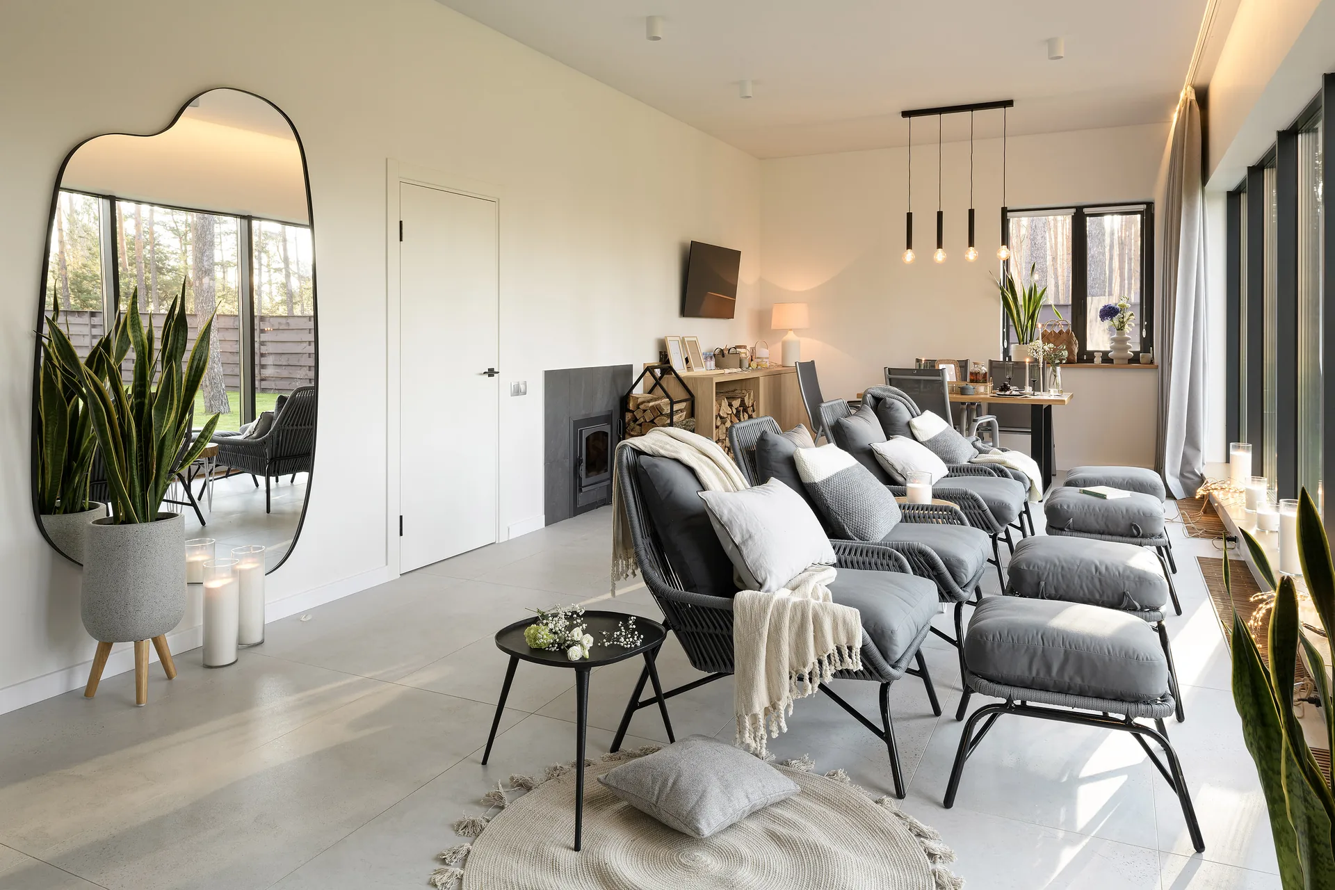 A bright Scandi Club lounge with armchairs, blankets and panoramic windows