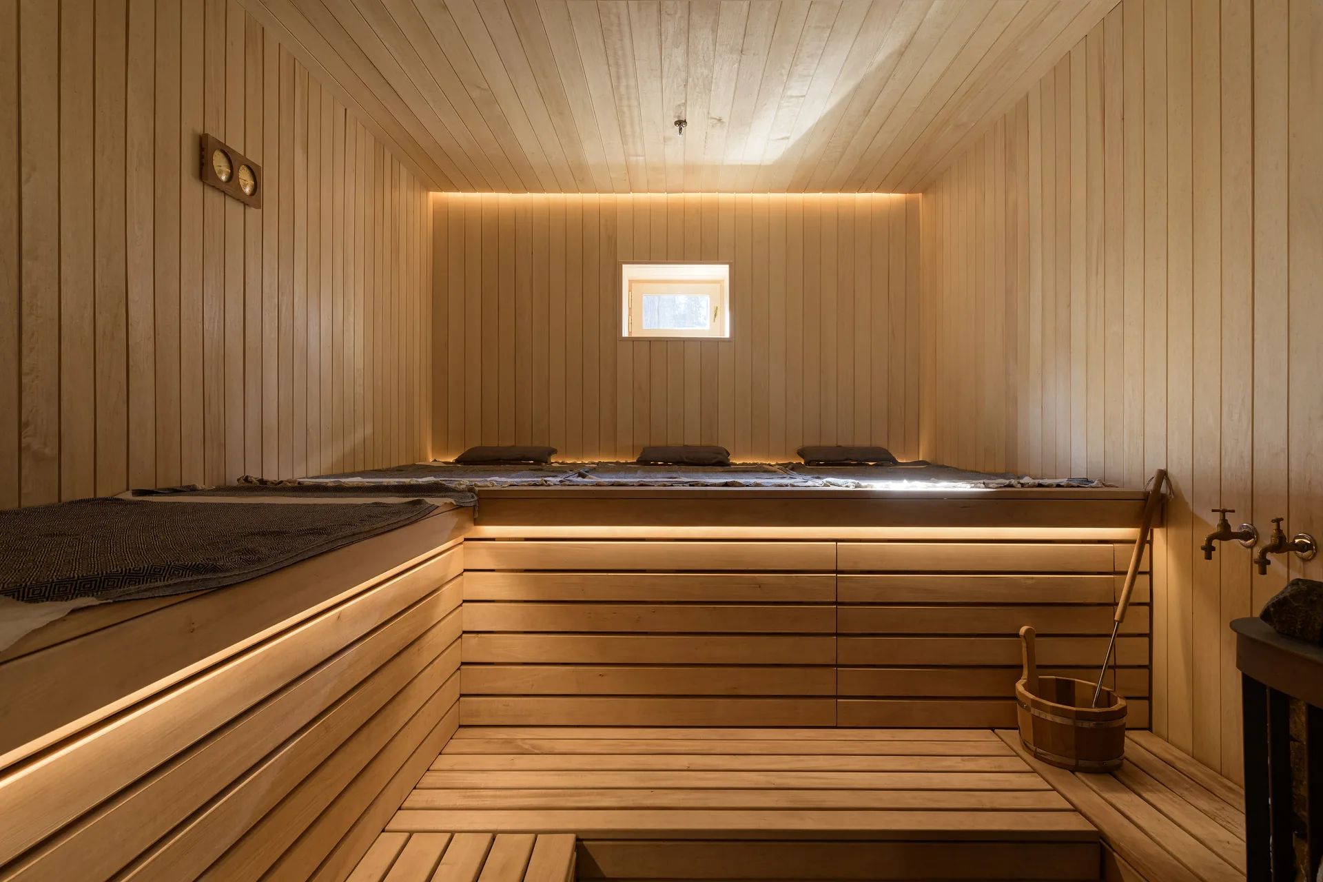 A wooden steam room with soft lighting